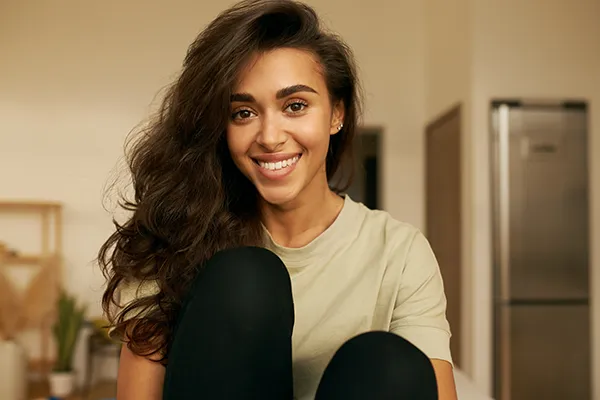 Gorgeous woman smiling to show off her brilliant teeth after a Bioclear treatment.