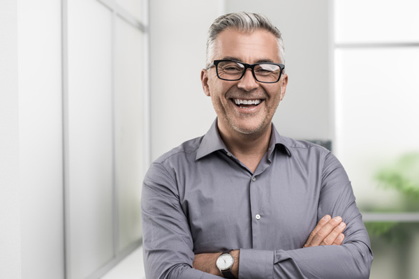 Man smiling with his arms crossed